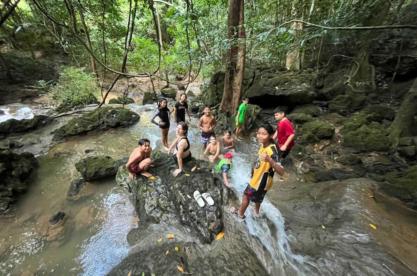 Kids playing in a waterfall